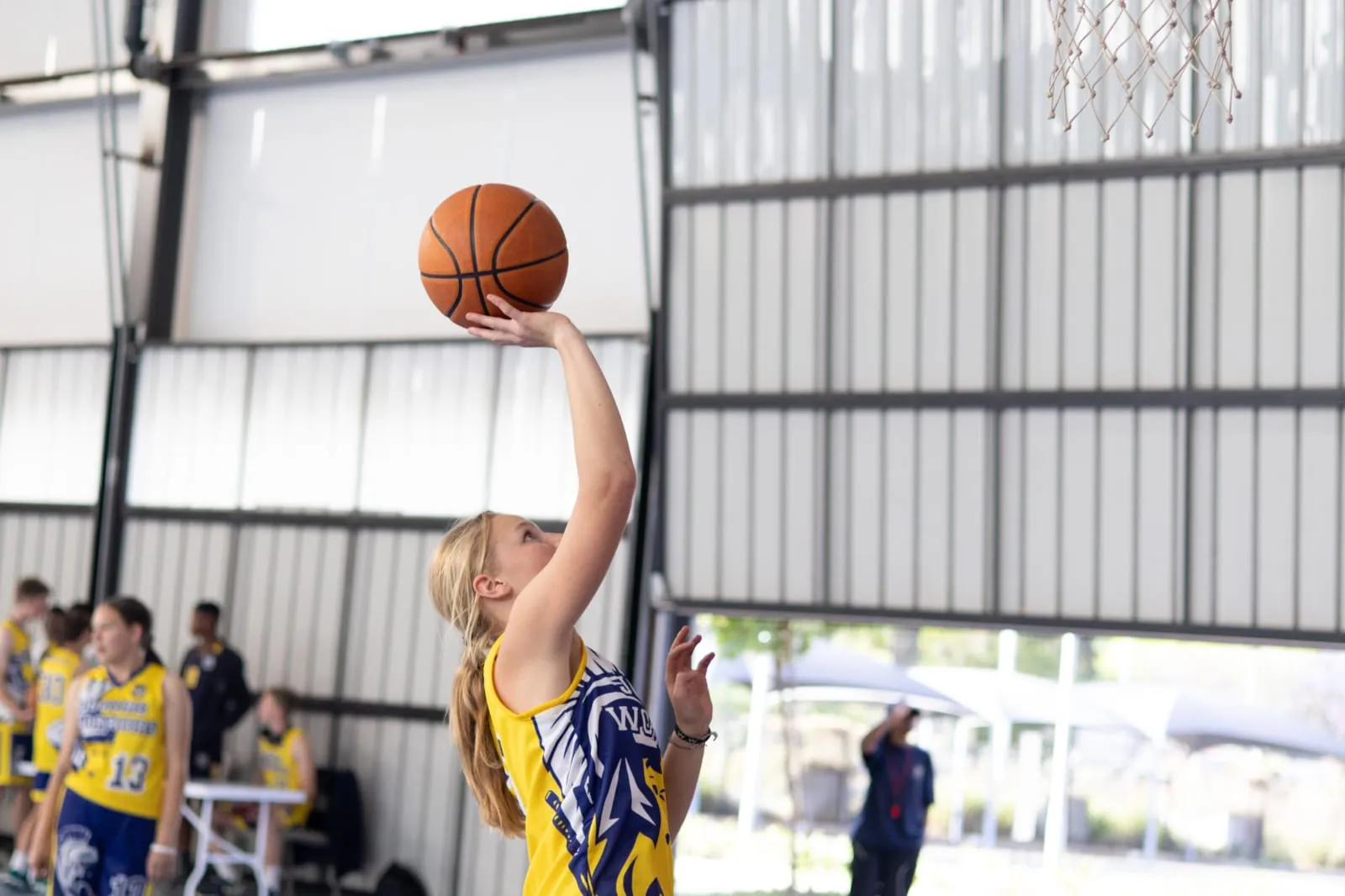 A Joburg Warriors player rising for a jump shot during an indoor game