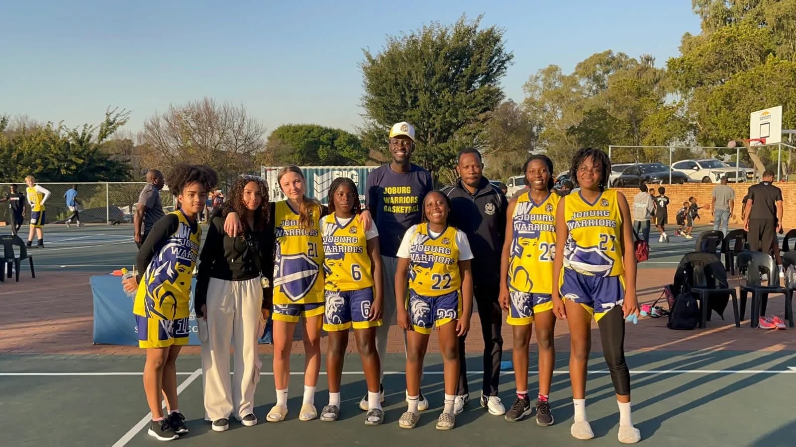 The Joburg Warriors girls' squad lined up with their coaches on an outdoor court